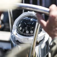 A compass, a view from above the steering wheel on a yacht